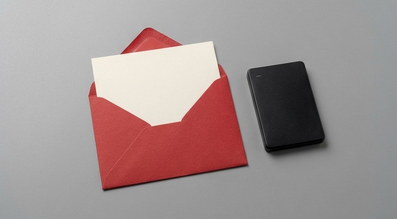 Conceptual AI illustration: A blank secret card inside a red envelope beside a storage device.