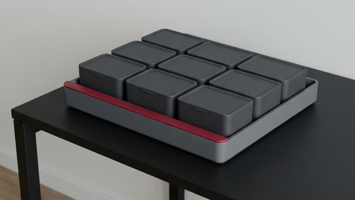 Conceptual AI illustration: Charcoal storage modules inside a tray with a crimson boundary.