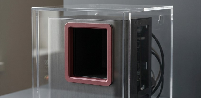Conceptual AI illustration: A service appliance inside a clear enclosure with a crimson access opening.